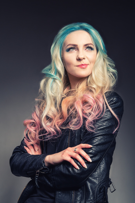 Smiled punk girl with colorful hair - studio portrait